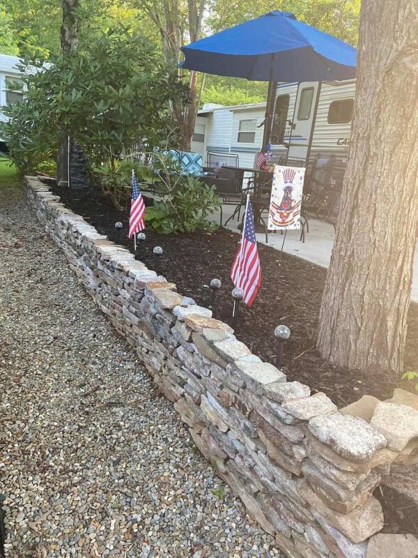 Deluxe Hillside site's garden and concrete patio