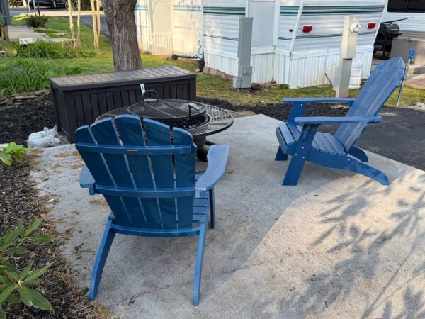 Adirondack chairs and firepit on patio at Mountain Vibes site Outdoor Resorts at Gatlinburg