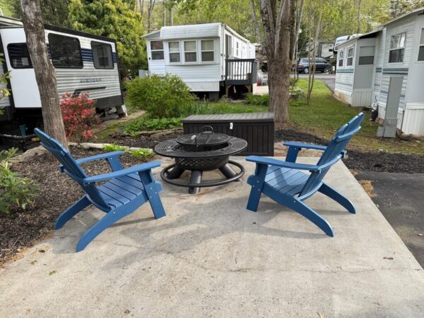 Adirondack chairs and firepit on patio at Mountain Vibes site Outdoor Resorts at Gatlinburg